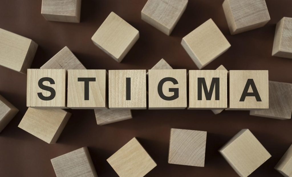 STIGMA Word In Wooden Cube against a dark background
